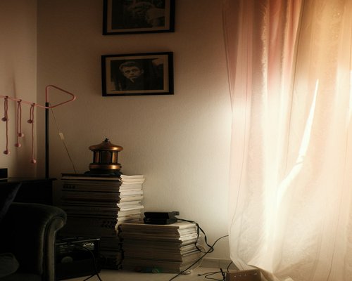A softly lit room with translucent curtains diffusing strong natural sunlight